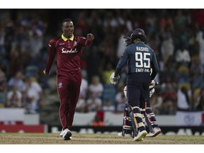 West Indies' Sheldon Cottrell celebrates taking the wicket of England's Adil Rashid during the second One Day International cricket match at the Kensington Oval in Bridgetown, Barbados, Friday, Feb. 22, 2019. West Indies won by 26 runs and Cottrell took five wickets.