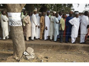 Voters line up to cast their votes during the Presidential and National Assembly election in Yola Nigeria, Saturday, Feb. 23, 2019. Africa's most populous country goes to the polls on Saturday to decide whether President Muhammadu Buhari deserves a second term. While more than 70 people are running to lead Nigeria, the close race comes down to Buhari and a billionaire former vice president, Atiku Abubakar.