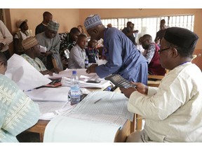 Electoral officials compile voting results at a collation center in Yola, n Nigeria, Sunday, Feb. 24, 2019. Vote counting continued Sunday as Nigerians awaited the outcome of a presidential poll seen as a tight race between the president and a former vice president.