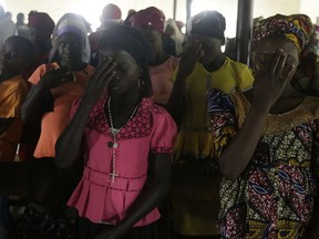 Nigerian women pray at St Charles Catholic Church, during a mass in Ngurore , Nigeria, Sunday, Feb. 17, 2019. Nigeria's top candidates on Saturday condemned the surprise last-minute decision to delay the presidential election for a week until Feb. 23, blaming each other but appealing to Africa's largest democracy for calm.