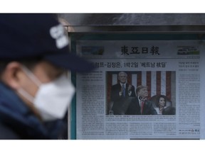 A man walks by a newspaper reporting U.S. President Donald Trump delivering his State of the Union address, displayed on a street in Seoul, South Korea, Thursday, Feb. 7, 2019. With the next meeting between Trump and North Korean leader Kim Jong Un set for Feb. 27-28 in Vietnam, there's hope and caution in South Korea on whether the leaders could agree to tangible steps toward reducing the North's nuclear threat after a year of soaring but fruitless talks.