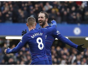 Chelsea's Gonzalo Higuain celebrates with Chelsea's Ross Barkley after scoring his side's fourth goal during the English Premier League soccer match between Chelsea and Huddersfield Town at Stamford Bridge stadium in London, Britain, Saturday, Feb. 2, 2019.