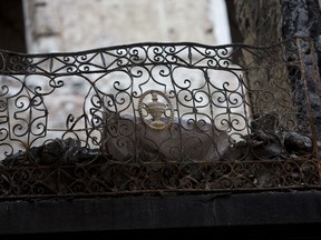 Debris still fills a fire damaged balcony of Brazil's National Museum in Rio de Janeiro, Brazil, Tuesday, Feb. 12, 2019. Five months after a devastating fire engulfed Brazil's National Museum, the facility is still in dire straits and efforts to rebuild slow-moving.