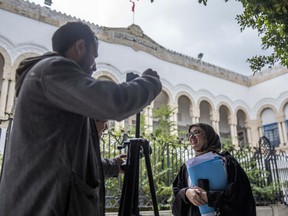 Imen Triqui, one of the defense lawyers talks to the Associated Press outside the Hall of Justice in Tunis, Friday, Feb.8, 2019. More than 40 people have been summoned to face trial over Tunisia's deadliest attack in a Mediterranean resort in 2015 and the verdict in expected Friday Feb.8, 2019, more than 3-1/2 years after the attack on the Imperial Hotel in the beach resort of Sousse left 38 people dead, mostly British tourists