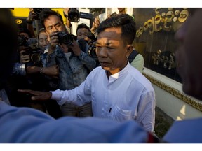 Myanmar police Capt. Moe Yan Naing, center, talks to journalists after his release from Insein prison in Yangon, Myanmar Friday, Feb. 1, 2019. The former police officer was sentenced to a year in jail for violating the Police Disciplinary Act after he testified during the trial of two Reuters journalists that he was ordered to help entrap the two who were accused of possessing state secrets.