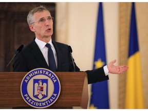 NATO Secretary-General Jens Stoltenberg gestures during a media statement in Bucharest, Romania, Thursday, Jan. 31, 2019. NATO's chief has called on China to treat detained two Canadian citizens "fairly and with due process."