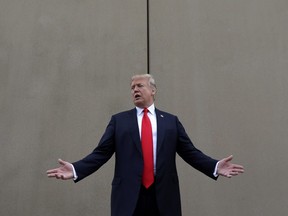 In this March 13, 2018, file photo, President Donald Trump speaks during a tour as he reviews border wall prototypes in San Diego.