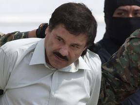 This Feb. 22, 2014 file photo shows Joaquin "El Chapo" Guzman, the head of Mexico's Sinaloa Cartel, being escorted to a helicopter in Mexico City following his capture in the beach resort town of Mazatlan.