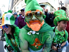 Parade goers pose on 5th Avenue during the 255th New York City St Patrick's Day Parade on March 17, 2016.