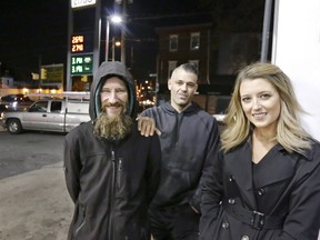 Johnny Bobbitt Jr., left, Katie McClure, right, and McClure's then-boyfriend Mark D'Amico pose at a Citgo station in Philadelphia.