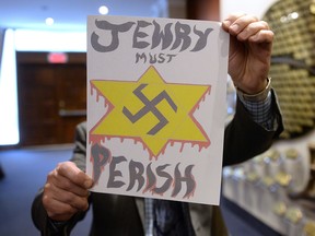 A piece of hate mail is held at a synagogue in Montreal on Dec. 19, 2017.