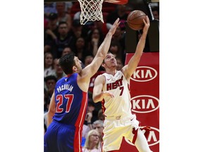 Miami Heat guard Goran Dragic (7) shoots against Detroit Pistons center Zaza Pachulia (27) during the first half of an NBA basketball game, Wednesday, March 13, 2019, in Miami.
