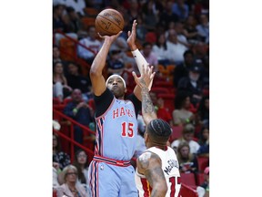 Atlanta Hawks forward Vince Carter (15) goes up to shoot gainst Miami Heat forward Rodney McGruder (17) during the first half of an NBA basketball game, Monday, March 4, 2019, in Miami.