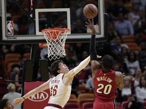 Miami Heat forward Justise Winslow (20) shoots as Cleveland Cavaliers forward Cedi Osman (16) defends during the first half of an NBA basketball game, Friday, March 8, 2019, in Miami.