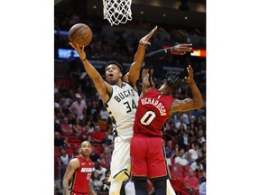 Milwaukee Bucks forward Giannis Antetokounmpo (34) goes up for a shot against Miami Heat guard Josh Richardson (0) during the second half of an NBA basketball game Friday, March 15, 2019, in Miami. The Bucks defeated the Heat 113-98.