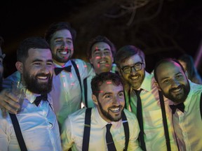 In this Feb. 16, 2019 photo, groom Juan Jose Pocaterra, center, poses for a photo with friends during his wedding party in La Llanada, a summer at the Camburito Hacienda in Acarigua, Venezuela. "Hosting a celebration amid these circumstances is obviously tough, but that's why we did the work at the hospital," said the 32-year-old co-founder and CEO of Vikua, a startup tech company whose name means "Quality of Life" and that Forbes magazine has called one of Latin America's most promising.