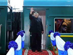 North Korea's leader Kim Jong Un waves before boarding his train at the Dong Dang railway station in Lang Son on March 2, 2019.