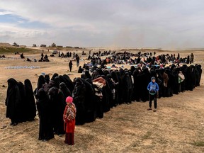 Civilians evacuated from ISIL's holdout of Baghouz wait at a screening area held by the U.S.-backed Kurdish-led Syrian Democratic Forces (SDF), in the eastern Syrian province of Deir Ezzor, on March 5, 2019.