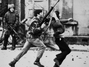 In this file photo taken on January 30, 1972, a British soldier is pictured dragging a Catholic protester during the "Bloody Sunday" killings, when British paratroopers shot dead 13 Catholic civil rights marchers in Derry.