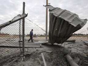 A Palestinian man walks past damage following an Israeli air strike targeting a site belonging to Gaza's Islamist rulers Hamas, in Khan Yunis in the southern Gaza Strip March 15, 2019.