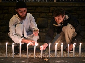 Well-wishers light 49 candles as they pay respects to victims outside the hospital in Christchurch, after a shooting incident at two mosques in the city.
