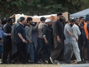 Mourners proceed with the coffin of a shooting victim at the Memorial Park cemetery in Christchurch on March 20, 2019.