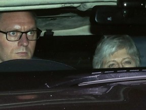 Britain's Prime Minister Theresa May (R) is driven out of the House of Commons in London on March 20, 2019.