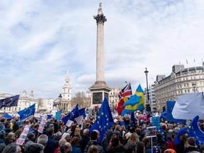 People pass Trafalgar Square on a march and rally organised by the pro-European People's Vote campaign for a second EU referendum in central London.