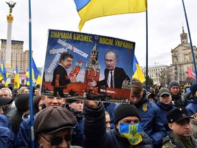 An activist of the Ukrainian far-right party National Corps holds an anti Ukrainian President placard reading "Corruption, offshores, political repressions" during their rally on Independence Square in Kiev.