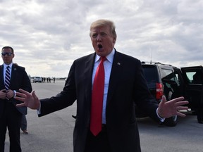 U.S. President Donald Trump speaks to reporters at Palm Beach International Airport March 24, 2019 in Palm Beach County, Florida, declaring he had been completely exonerated after his campaign was cleared of colluding with Russia in the 2016 election campaign.