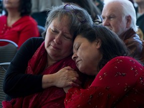 Mariette Buckshot and Margaret Swan, left, console each other during an Indian Day school litigation announcement in Ottawa, Tuesday, March 12, 2019.