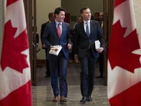 Prime Minister Justin Trudeau and Finance Minister Bill Morneau speak as they walk to the House of Commons in Ottawa, Tuesday March 19, 2019.