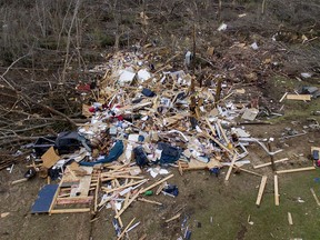 Debris litters a yard the day after a deadly tornado damaged a home in Beauregard, Ala., Monday, March 4, 2019.