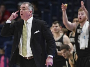 Wofford head coach Mike Young talks to the team from the sidelines during the first half of an NCAA college basketball game against Samford Saturday, March 2, 2019, in Birmingham, Ala.