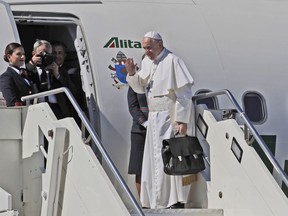 Pope Francis waves as he boards the airplane for Rabat, Morocco at Rome's Fiumicino International airport, Saturday, March 30, 2019. Francis's weekend trip to Morocco aims to highlight the North African nation's tradition of Christian-Muslim ties while also letting him show solidarity with migrants at Europe's door and tend to a tiny Catholic flock on the peripheries.