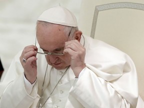 Pope Francis wears his glasses as he arrives in the Paul VI Hall at the Vatican for a audience with students, family and teachers of the Barbarigo catholic school of Padua, Saturday, March 23, 2019.