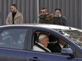 Pope Francis waves as he leaves St. John Lateran Basilica after meeting Roman clergy, in Rome, Thursday, March 7, 2019.