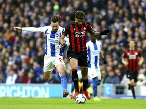 Brighton's Davy Propper, left, vies for the ball with  Huddersfield Town's Philip Billing, during the English Premier League soccer match between Brighton and Huddersfield Town,  at the AMEX Stadium, in Brighton, England, Saturday, March 2, 2019.