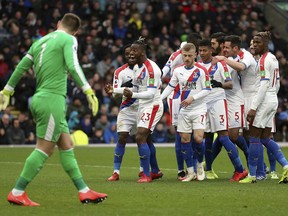 Crystal Palace's Michy Batshuayi celebrates scoring his side's second goal of the game with teammates, during the English Premier League soccer match between Burnley and Crystal Palace,  at Turf Moor, in Burnley, England, Saturday, March 2, 2019.