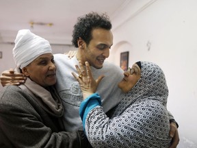 Mahmoud Abu Zaid, center, a photojournalist known as Shawkan, is hugged by his parents at his home in Cairo, Egypt, Monday, March 4, 2019. Shawkan was released after five years in prison.