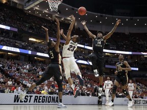 Florida State guard Terance Mann, right, vies for a rebound with Gonzaga guard Zach Norvell Jr., middle, and Florida State's Trent Forrest during the first half an NCAA men's college basketball tournament West Region semifinal Thursday, March 28, 2019, in Anaheim, Calif.