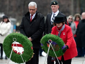 Silver Cross Mother Anita Cenerini, right, and Parliamentary Secretary to the Minister of Veterans Affairs and Associate Minister of National Defence Stephane Lauzon, left, participate in a wreath laying during a ceremony honouring Canadians who served and died during Canada's mission in Afghanistan, at the National War Memorial in Ottawa on Sunday, March 31, 2019.