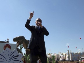 Turkey's President Recep Tayyip Erdogan speaks in front of a model dinosaur during the inauguration of a theme park in Ankara, Turkey, Wednesday, March 20, 2019. Erdogan has sparked a diplomatic spat with New Zealand and Australia as he campaigns for votes in local elections this month and portrays the mosque shooting in New Zealand and a World War I battle as targeting Islam.