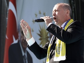 Turkey's President Recep Tayyip Erdogan sings a political song before his address to the supporters of his ruling Justice and Development Party, AKP, during a rally in Ankara, Turkey, Saturday, March 23, 2019, ahead of local elections scheduled for March 31, 2019.