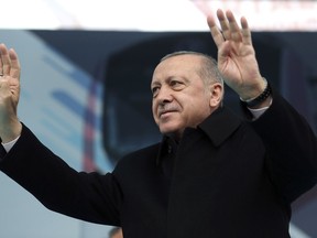 Turkey's President Recep Tayyip Erdogan waves as he addresses the supporters of his ruling Justice and Development Party, AKP, during a rally in Istanbul, Tuesday, March 12, 2019, ahead of local elections scheduled for March 31, 2019. (Presidential Press Service via AP, Pool)