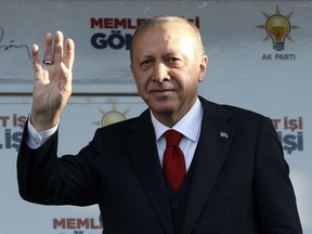 Turkey's President Recep Tayyip Erdogan addresses the supporters of his ruling Justice and Development Party during a rally in Kutahya, Turkey, Thursday, March 21, 2019. Erdogan has again screened clips of a video taken by the Christchurch mosque gunman, a day before the foreign minister of New Zealand _ which is trying to stop its use _ is due in Turkey.(Presidential Press Service via AP, Pool)