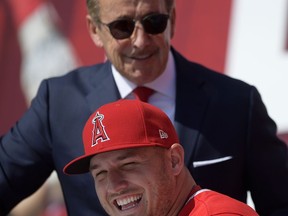Los Angeles Angels owner Arte Moreno, top, stands next to center fielder Mike Trout during a news conference to talk about Trout's 12-year, $426.5 million contract, prior to the team's exhibition baseball game against the Los Angeles Dodgers Sunday, March 24, 2019, in Anaheim, Calif.