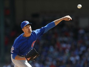 Chicago Cubs starting pitcher Cole Hamels throws during the first inning of a baseball game against the Texas Rangers in Arlington, Texas, Sunday, March 31, 2019.