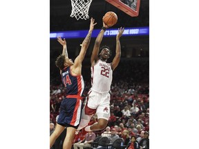 Arkansas forward Gabe Osabuohien (22) drives to the hoop against Mississippi defender KJ Buffen (14) during the first half of an NCAA college basketball game, Saturday, March 2, 2019 in Fayetteville, Ark.