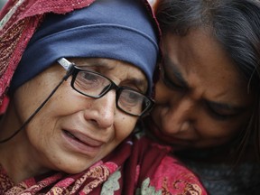 A woman who lost her husband during Friday's mass shootings cries outside an information center for families, Saturday, March 16, 2019, in Christchurch, New Zealand.